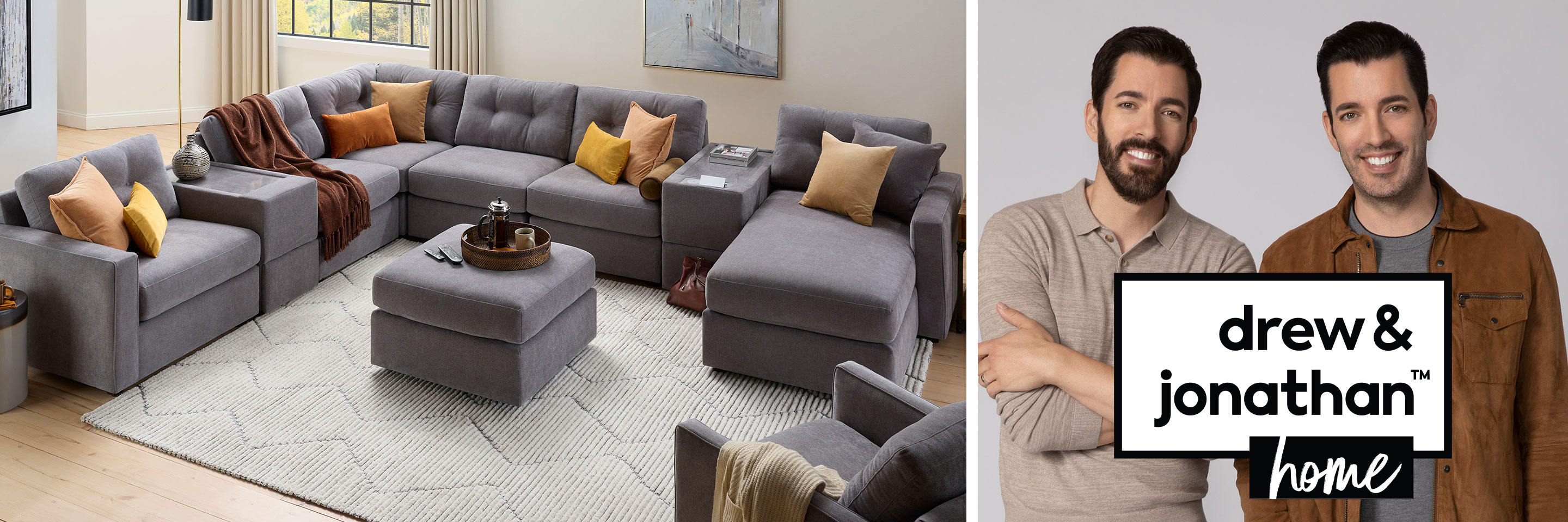 Drew and Jonathan Home featuring Drew and Jonathan, and the gray modular one sectional with orange and gray accent pillows.