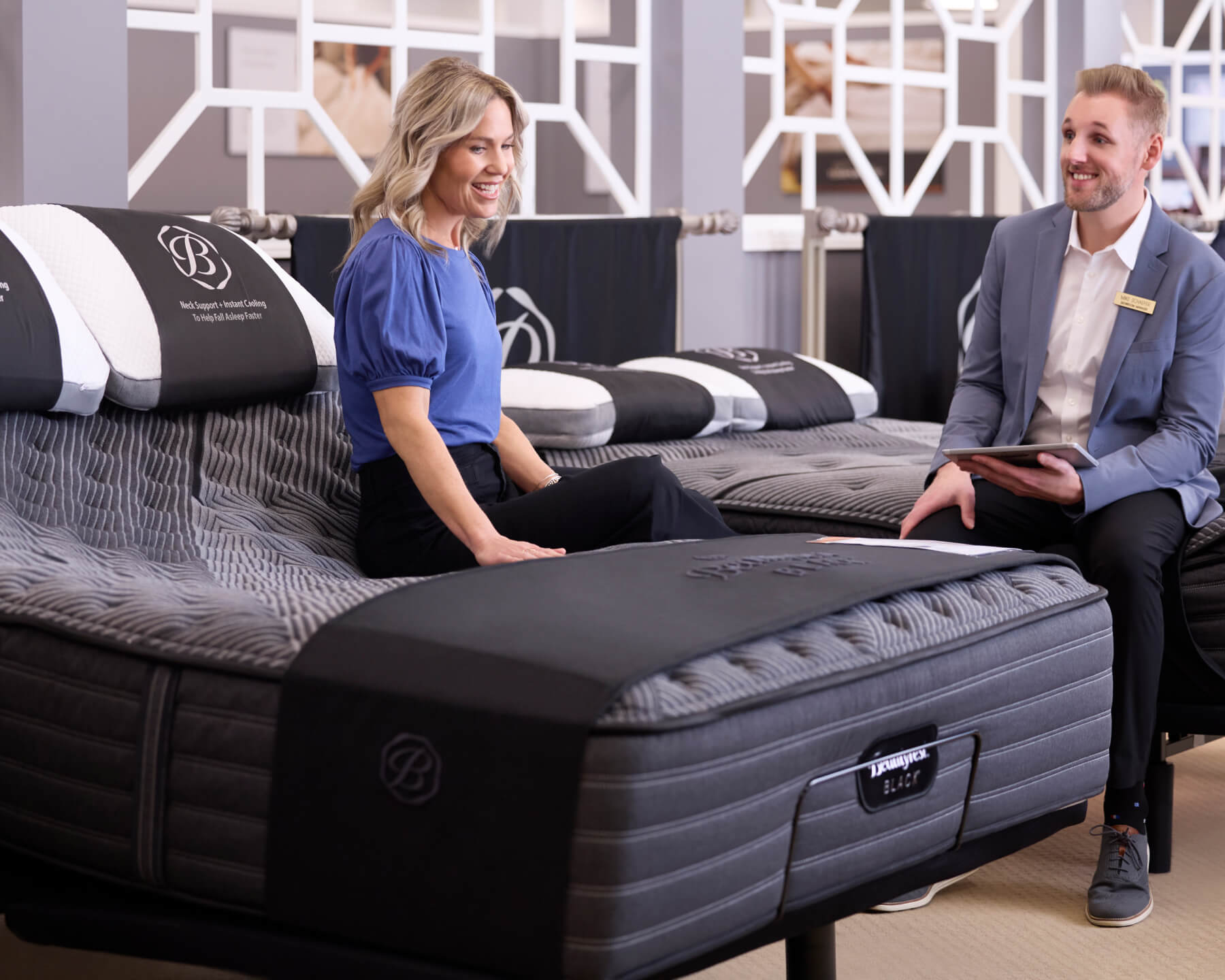 home furnishing consultant working with a customer in the showroom mattress gallery