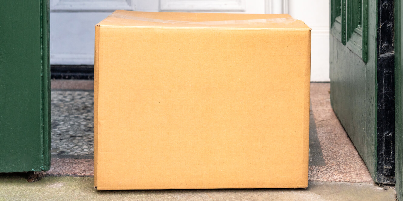 an image of a box delivered to a customers door, for the ground shipping as a delivery method